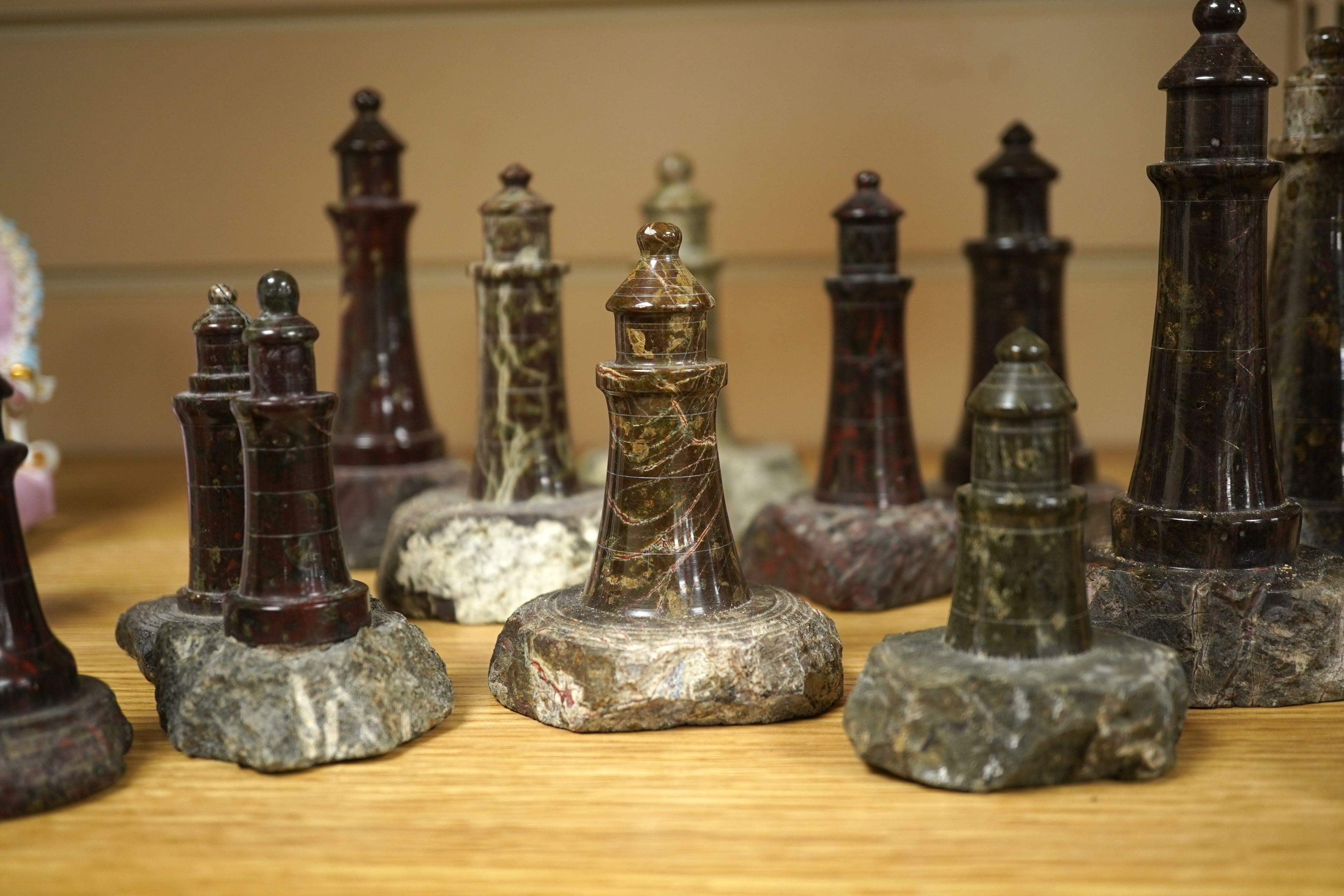A collection of Cornish serpentine stone carved lighthouses, tallest 13cm high